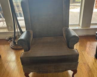 There are a pair of these leather wing-back chairs.