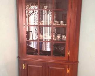 Lighted corner cabinet with glass front and glass shelves