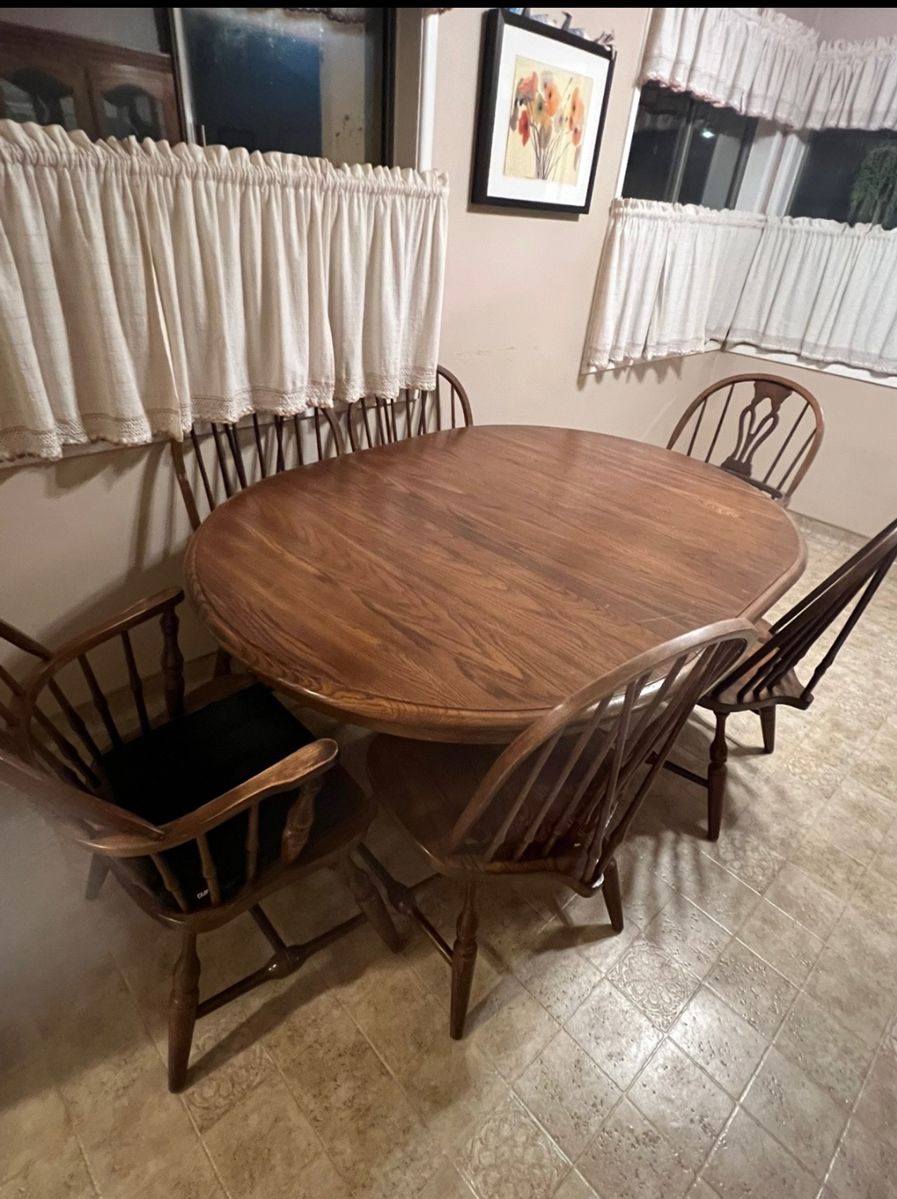 Dinning room table, 6 chairs ( 2 are arm chairs), 1 leaf, padded protective cover for top.