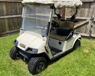  Golf cart year 2000. Works but needs batteries. Comes with charger, cover, and extra tires.