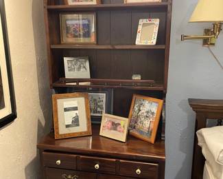 framed art and Ethan Allen bookcase