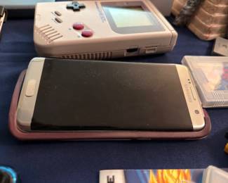 Samsung smartphone with protective case and handheld game device