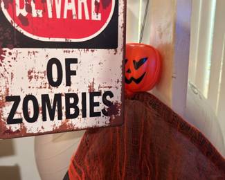 Beware of Zombies sign and pumpkin bucket