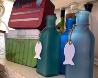 Blue glass bottles with cork and fish tags