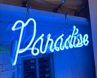 Blue neon "Paradise" sign