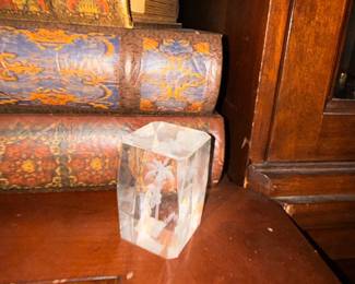 Decorative faux books and small carved wooden box on wooden shelf