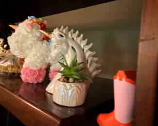 Floral arrangement in ceramic vase and miniature pink rain boots decor