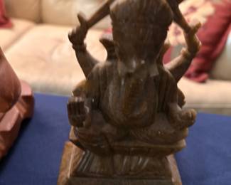 Carved wooden deity sculpture with musician figure