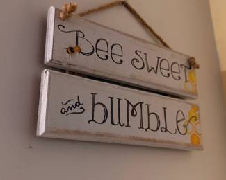 Wooden sign with bee motif and text 'Bee sweet and bee humble'
