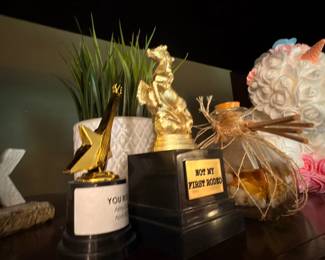 'Best Pitmaster' trophy and coastal decor including starfish, seashell arrangement and greenery