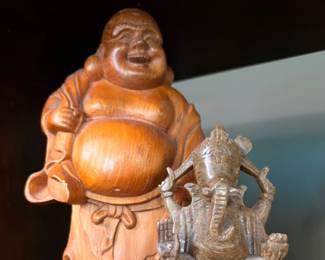Figurines: Laughing Buddha and Hindu goddess statue