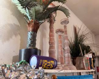 Artificial palm tree, decorative column, and table of assorted ornaments