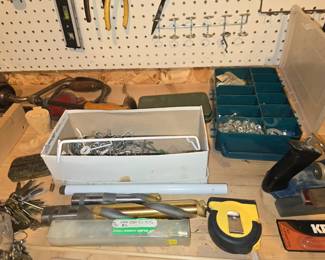 Box of pegboard hangers and some very large bits.  Also a key collection