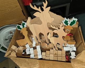 This is a whole box of cutout wood reindeer, some partly painted and some polaroid's of finished pieces.