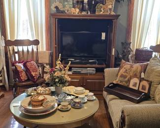 There are two matching wood accent loveseat sofas in this room. They are both a sage color, textured with a ribbed pattern.
