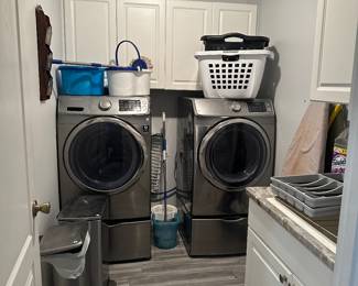 Front loader washer and dryer. Storage containers on bottom are not for sale