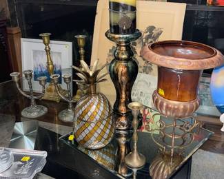 A top the large glass, modern dining table with 4 chairs you'll find various brass and related items