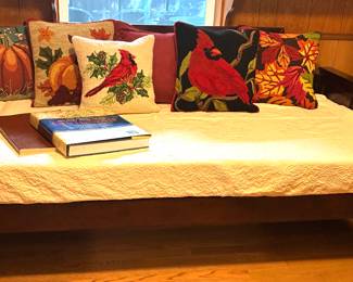 Needlepoint pillows, mahogany daybed