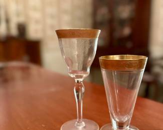 Gold-rimmed Glastonbury-Lotus Minton glasses. Eight juice glasses and four cordials available.