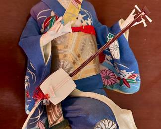 Geisha doll with shamisen (three string musical instrument).