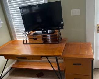 Office desk, filing cabinet, monitor. The desk and filing cabinet are part of a set (see next photo) but can also be purchased separately. Desk measures 55"L x 29"H x 28"W. Filing cabinet measures 28"H x 18"W x 22" D