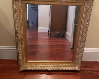 Intricate framed gilded mirror, measures 32" H x 28" W