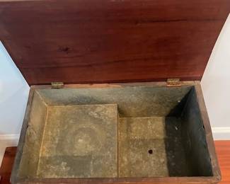 Zinc lining with plug on the right lower side to allow for drainage of melted ice.