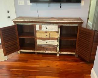 TV console, cabinet doors open.