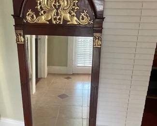 Full-length Empire style mirror with gilded sphinxes and gilded accents on columns and base.