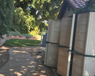 Several Rubbermaid storage walk in storage containers double doors.