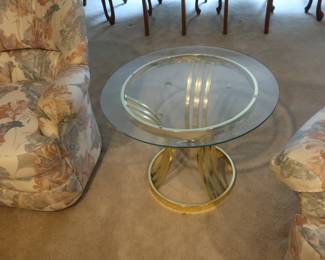 round  glass  top  and  brass  table     It  is 27".