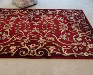 Red  and  gold  wool  rug  Size  is  4"  9"  x  7"  5"