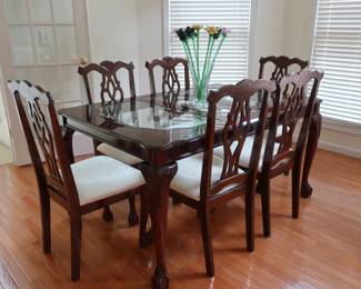 Mahogany  color  dinette set with 6  chairs.  There  are  glass inserts. It  is  60"  x  39".