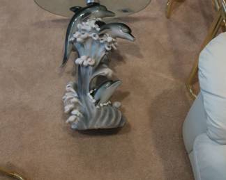 glass top table with dolphin base