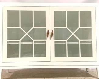 1523 - Chelsea House Silhouette Chest 36" x 48" x 18" Making storage practical and aesthetically pleasing, the Silhouette Chest features a white painted finish with windowpane doors exposing the double shelving inside. Finished with rose quartz stone door pulls for a glamorous detail. Designed by Lisa Kahn.