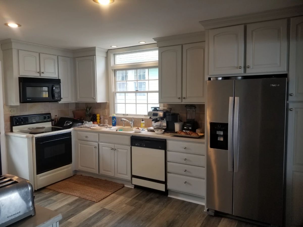 Small kitchen with white cabinetry