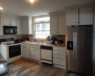 Small kitchen with white cabinetry