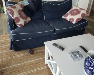 Navy couch with white piping; coastal chic coffee table