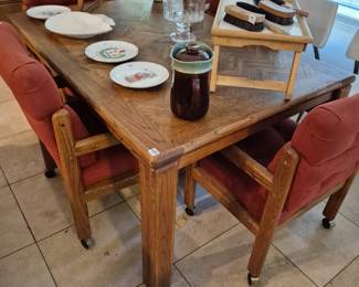 Oak dining set with six rolling chairs