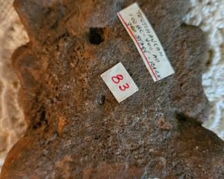 Back of the clay artifact. Seems it was bought at an auction. The stickers were left on it.