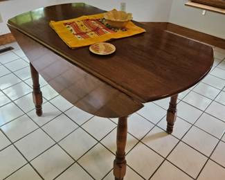 Walnut 46" diameter drop leaf kitchen table. Beautiful condition.