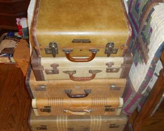 Assorted vintage suit cases