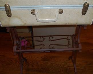 Vintage suitcase on metal stand
