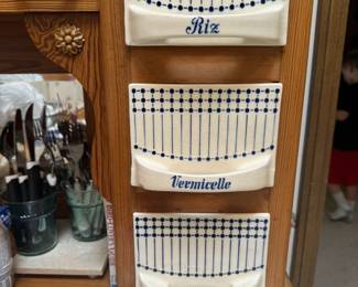 Parlez-vous français? This charming French Country oak cabinet with ceramic storage bins is labeled with decorative French names.