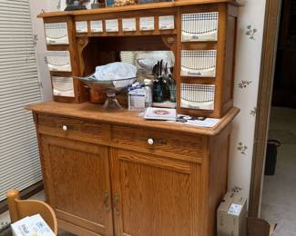 Parlez-vous français? This charming French Country oak cabinet with ceramic storage bins is labeled with decorative French names.