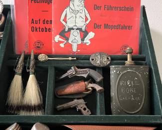 Extensive selection of interesting jewelry and smalls, including two vintage German hunter hat brooches, two Russian oil cans or weapon oiler bottles, a collection of German comedian Herbert Hisel EPs, vintage miniature pistols, and more.