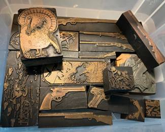 Antique wood block, stamps, featuring firearms and hunting themes.