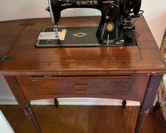 Antique Singer sewing machine with cabinet.