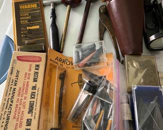 Numerous hunting tools and accessories including muzzleloader ball starters; vintage powder and shot measure; antique bullet mold; many arrowheads; and more.