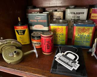Numerous tins of rifle powder, shotgun powder, pistol powder, gun, oil, and more.